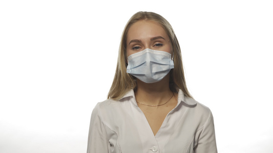 戴着医用口罩的年轻医生正在工作中经历偏头痛视频