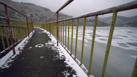 来自冰冻湖泊和雪林桥梁的美丽的冬季风景视频