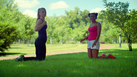 两个女孩在草地上做瑜伽视频