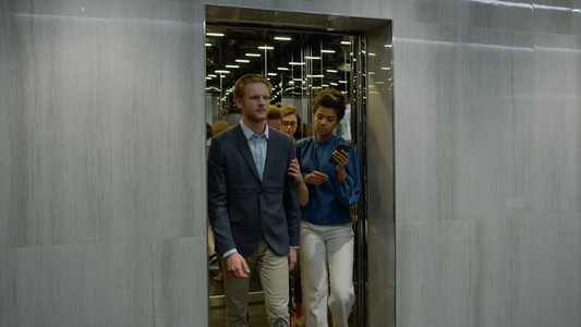 商务人士们在走廊的电梯里视频