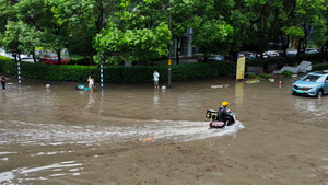 4K航拍夏季暴雨过后路面积水严重外卖员骑车淌水21秒视频