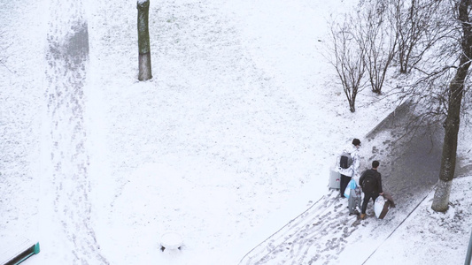 春节雪地里拉着行李箱返乡回家的人视频