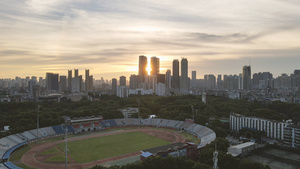 航拍城市风光落日晚霞夕阳天空城市体育场素材50秒视频