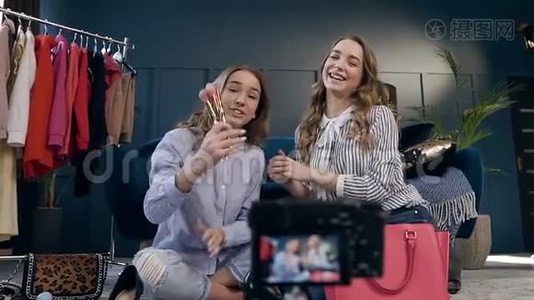 两位女性时尚博主在vlog上录制化妆教程，分享社交媒体。视频