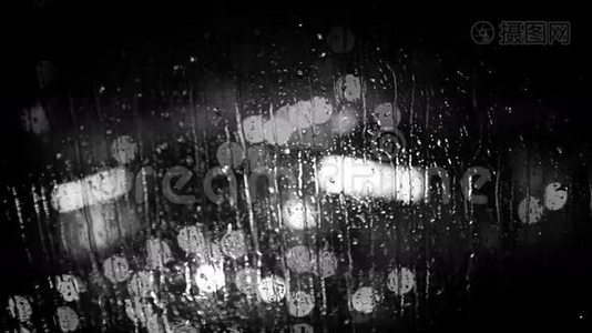 雨中透过窗户玻璃看到的城市灯光。 黑白镜头。视频