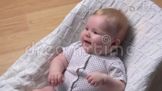 可爱的宝宝躺在婴儿椅上，开心地笑视频