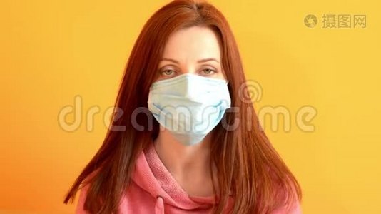 红孩儿女人冷静地戴上口罩，黄色背景，保护病毒视频