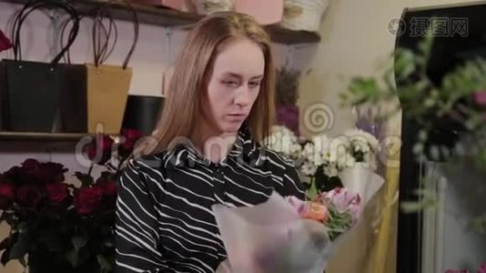 专业的花店正在包装一束花。 为国际妇女节准备`美丽的花束..视频