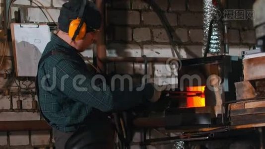 一个铁匠在炉子里加热热的细节视频