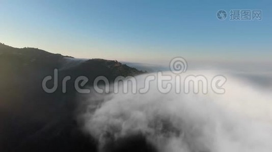 早晨，无人机在厚厚的云层下拍摄群山视频