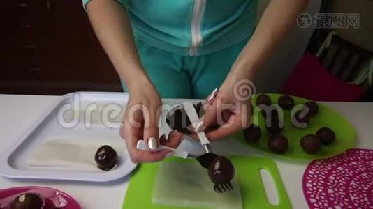 一个女人躺在巧克力海绵蛋糕的表面球上。 上面洒满了。 做一个土豆蛋糕。 盘子旁边是蛋糕的空白视频