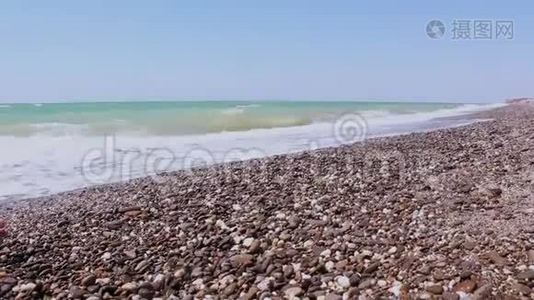 看暴风雨的大海和海岸。 海浪在卵石滩上翻滚。 海上的风暴。视频