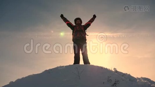 阿拉斯加的旅行者来到一座雪山的山顶，为战胜冬日的日落而欢欣鼓舞。 登山者之旅视频