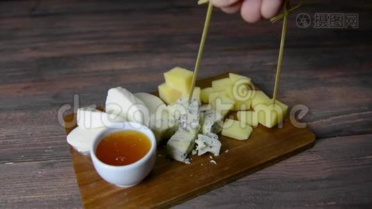 奶酪盘和蜂蜜。 人类的手视频