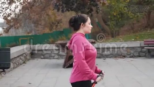 北欧步行概念。 年轻专注的胖乎乎的女性每天都会在楼梯上散步，这是她减肥锻炼的一部分视频