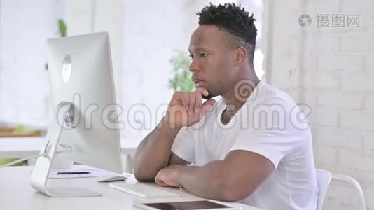 漫不经心的非洲男人在桌面上思考和工作视频