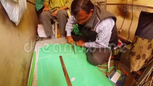 印度裁缝用大剪刀缝制车间Bikaner从绿色材料中裁剪图案视频