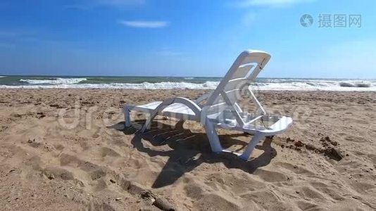 白色塑料日光浴床矗立在海边的沙滩上视频