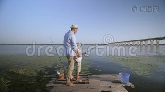 父亲是一位热心的父亲，年轻的父母一家人在河边教他心爱的小渔夫的手艺视频