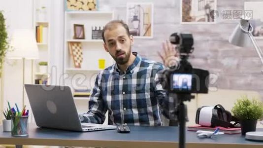 著名年轻的vlogger说话时在笔记本电脑上打字视频
