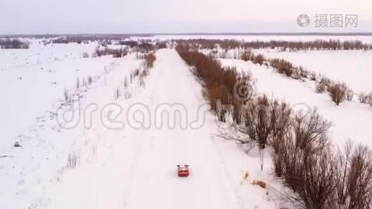 橙色汽车乘坐冬季雪道，顶景..视频