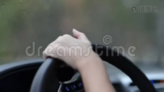 女人的手在车里转动方向盘。 方向盘上部的特写，选择性聚焦视频