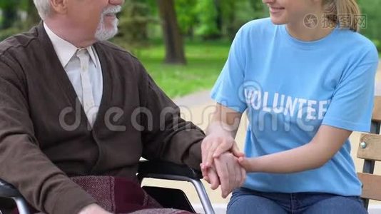 真诚的女志愿者牵着残疾退休人员的手，支持临终关怀视频
