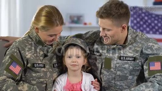 男兵和女兵戴着军帽拥抱女儿，对着镜头微笑视频