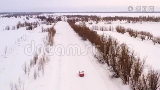 一辆车正沿着一条冬天下雪的乡村道路行驶。 从无人驾驶飞机上俯瞰。视频