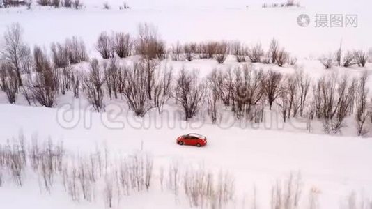 一辆车正沿着一条冬天下雪的乡村道路行驶。 从无人驾驶飞机上俯瞰。视频