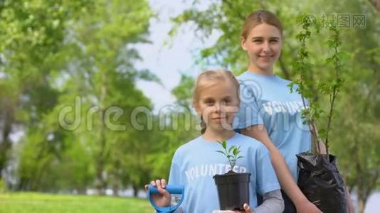 小女孩和年轻妇女抱着树苗，生态志愿项目视频