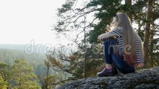 女孩坐在岩石上视频
