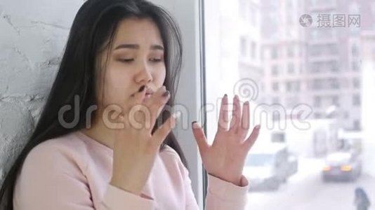 年轻的亚洲女人尖叫着，疯狂地坐在窗前视频