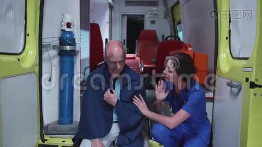 穿制服的护士跟病人说话，让他冷静下来。视频