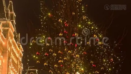建筑物上的圣诞灯和街上树上的球。视频