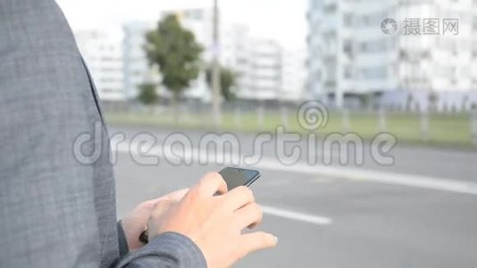 一个男人手里拿着手机，控制着手指姿势，看着社交网络视频