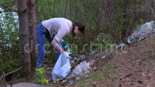 志愿者在公园湖边的森林里捡垃圾，收集垃圾。视频