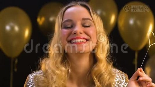 带着心形孟加拉灯微笑的金发女人情人节庆典视频