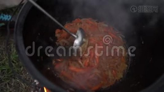 用一个大锅煮小块肉，在室外用邋遢的汤视频