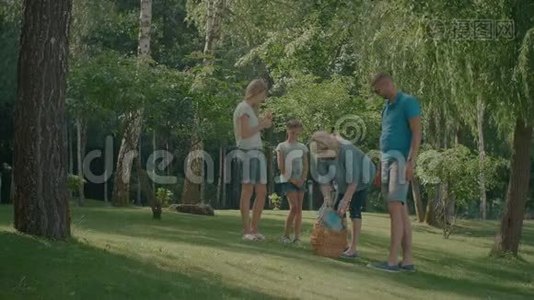 快乐的一家人在公园里放野餐毯视频