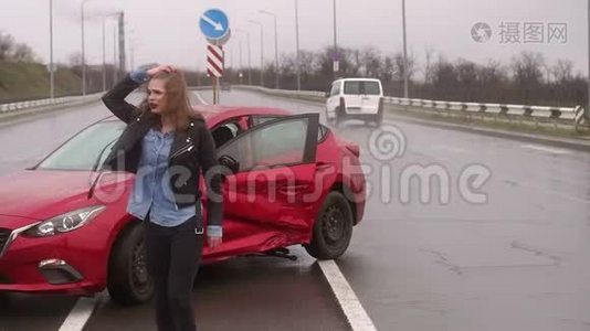 一个女人在雨中的道路上发生了事故，她受伤了，害怕了。视频