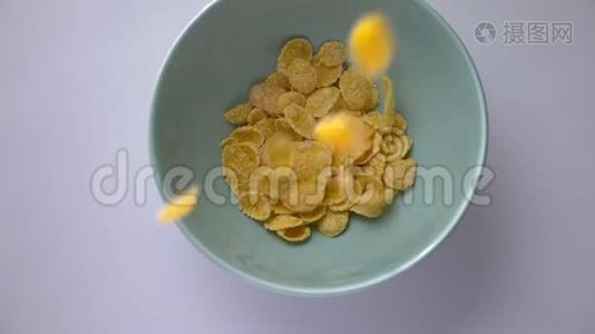 玉米片的特写镜头落在碗里。 健康可口的所有美式早餐食品视频