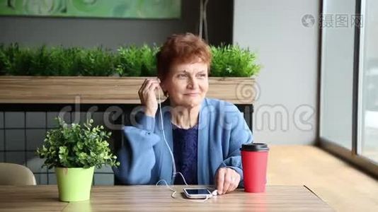 老年妇女，带耳麦和电话。视频