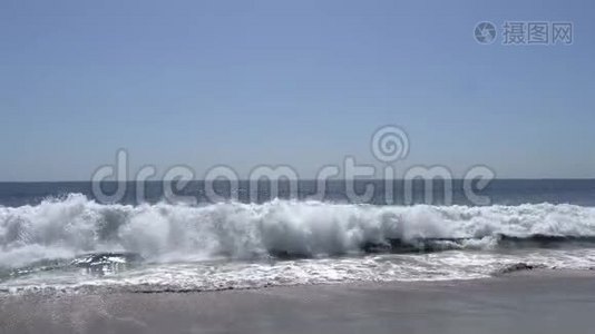太平洋的波浪在加州马里布海滩的岸边拍打。 沙滩上温暖阳光的夏日视频