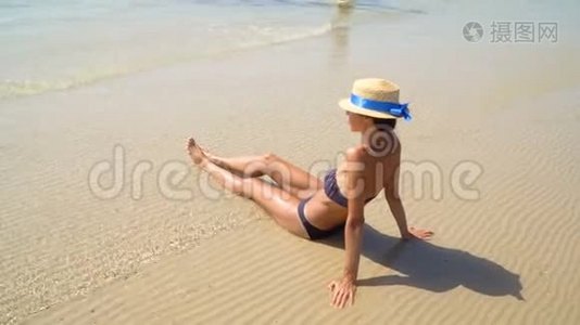 夏季生活方式高清视频漂亮年轻晒黑的女人戴帽子。 享受生活，坐在海滩上，时间到了视频