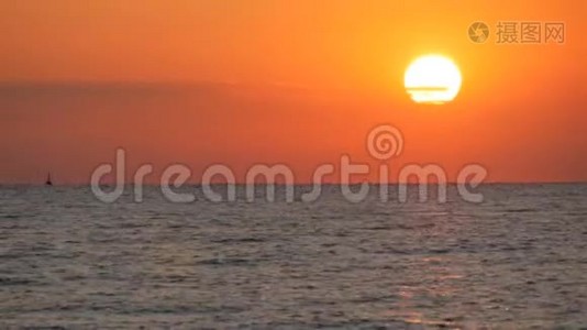 在海面上，巨大的、圆圆的、红色的日落或黎明。 在海面上反射阳光和日出视频