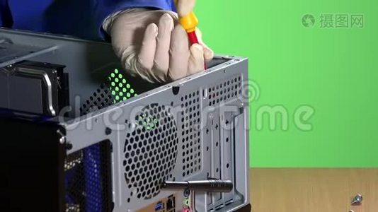 技术人员双手拧开并从电脑机箱上拆下图形卡。视频