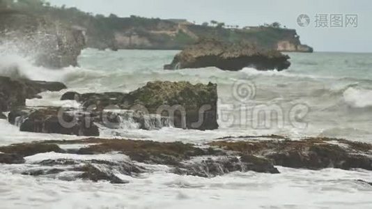 在巴厘岛附近，缓慢的石质和岩石海岸有强烈的波浪和风。 泰格旺吉海滩。 印度尼西亚。视频