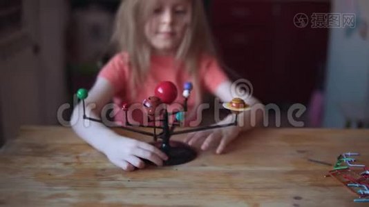 小金发女孩在玩太阳系的布局。视频