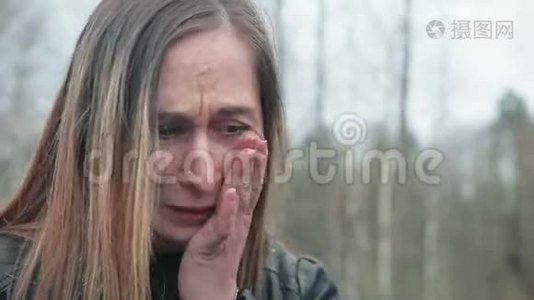 年轻的棕色头发的女人哭着在一辆破车的引擎盖附近抽烟视频